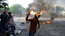 Protesters throwing molotov cocktails in Thailand.